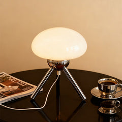 Mushroom-shaped glass table lamp with metal tripod base, bedroom bedside ambient light