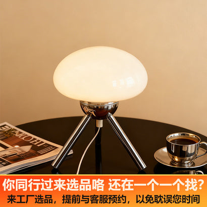 Mushroom-shaped glass table lamp with metal tripod base, bedroom bedside ambient light